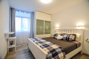 En eller flere senge i et værelse på Prosurfing Apartamento + 36 billeder