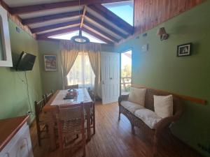 a living room with a couch and a table at Cabañas Puerto Ensenada in Pichidangui