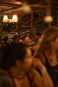 a group of people sitting at a bar at REFUGIO LA ROCA in Los Santos