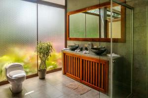 a bathroom with two sinks and a toilet at Saguamby Mindo Lodge in Mindo +78 photos