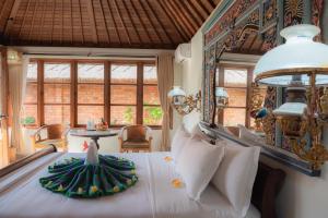 a bedroom with a large white bed with a large window at The ARIRAS Resort in Candidasa +90 photos