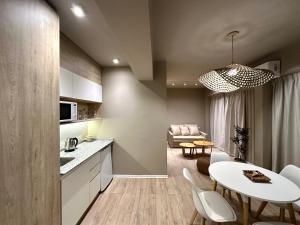 a kitchen and living room with a white table and chairs at Bari 413 in La Rioja