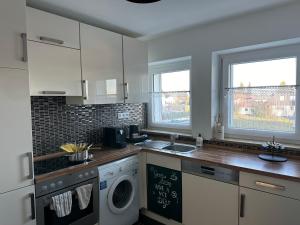 a kitchen with a washer and dryer in it at Rose in Rosenfeld