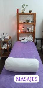a bedroom with a bed with a purple blanket at HOSTAL , Habitación en vivienda familiar in Buenos Aires