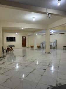 a large empty room with chairs and a table at RECANTO BUSCAPE in Alto Caparao