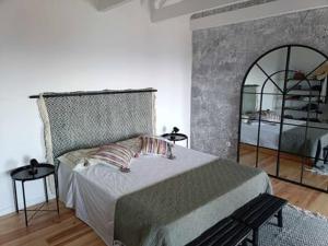 a bedroom with a large bed and a mirror at Our Place in Pico in Companhia de Cima