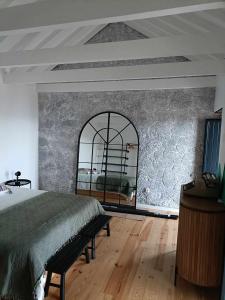 a bedroom with a large bed and a large window at Our Place in Pico in Companhia de Cima