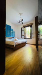 a bedroom with a bed with blue cabinets and a window at Batroun Old Town private duplex with garden in Batroûn