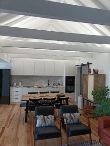 a living room with a table and chairs and a kitchen at Our Place in Pico in Companhia de Cima