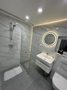 a bathroom with a shower and a sink and a toilet at Cibalae Residence, Self Check-In in Vinkovci +70 photos