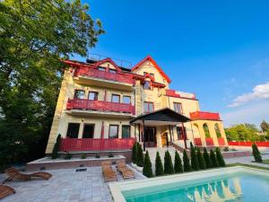 a large house with a swimming pool in front of it at Diamond 2 in Palić