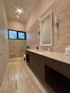 a bathroom with a sink and a mirror and a shower at Casa Continental Hotel Boutique & Suites - Adults Only in Mérida