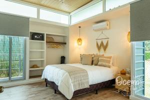 a bedroom with a bed and a large window at Oceantide Playa Hermosa in Playa Hermosa +20 photos