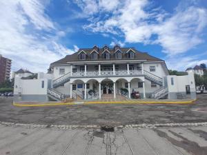 a large white building with a roof at Beach Studio 10 in Ocho Rios