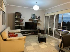 a living room with a couch and a television at Altos Resistencia in Resistencia