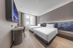 a hotel room with two beds and a flat screen tv at Atour Light Hotel Chengdu Yulin Street Nijia Bridge in Chengdu +23 photos