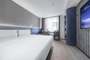 Gulta vai gultas numurā naktsmītnē Atour Light Hotel Chengdu Yulin Street Nijia Bridge