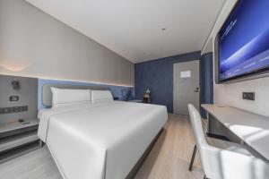 Gulta vai gultas numurā naktsmītnē Atour Light Hotel Chengdu Yulin Street Nijia Bridge