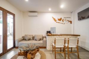 a living room with a couch and a table and chairs at Baliterraneo Boutique Resort in Seminyak +37 photos