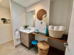 a bathroom with a sink and a mirror at Panda's Patch Dunsborough in Dunsborough