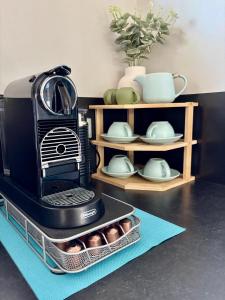 a black coffee maker sitting on top of a counter at Panda's Patch Dunsborough in Dunsborough