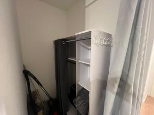 a black cabinet with a curtain in a room at Cologne City Studioaparment in Cologne