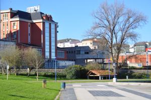 a street in a park with buildings in the background at Hotel Crunia I A Coruña in A Coruña