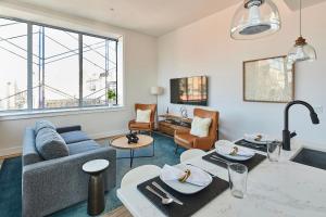 a living room with a couch and a table at Prime Hoboken Lofts in Hoboken