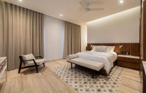 a hotel room with a bed and a chair at Casa Continental Hotel Boutique & Suites - Adults Only in Mérida