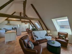 a living room with two chairs and a table at Gîte en forêt avec jardin, terrasse et parking près de la Loire - FR-1-590-530 in Saint-Firmin-sur-Loire
