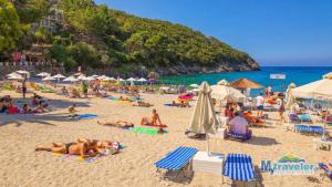 a group of people laying on a beach at Studios Kapsalas in Nea Michaniona
