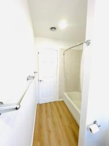 a bathroom with a white tub and a shower at Cozy Home Silicon Valley 1 in San Jose