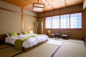 Postel nebo postele na pokoji v ubytování 岡山楽禅庵 Raku-Zen-An 岡山門田文化町の隠れ高級旅館 静寂と四季の彩りに包まれる優雅な滞在 無料駐車場有り supported by COCOSTAY