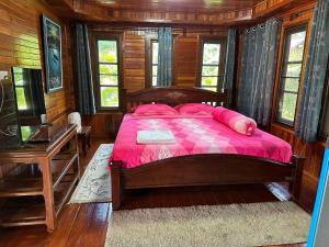 Un dormitorio con una cama, un escritorio y ventanas. en Thip Siam Village, en Ao Nam Mao 43 fotos más