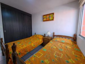 Ένα ή περισσότερα κρεβάτια σε δωμάτιο στο Casa Azahares Atlixco