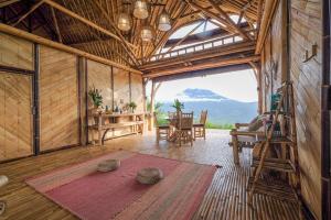 a large room with a table and chairs in a building at Laputa Bali in Sidemen