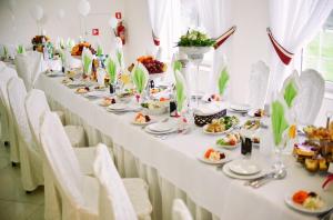a long table with plates of food on it at Dwór Olimp in Stalowa Wola