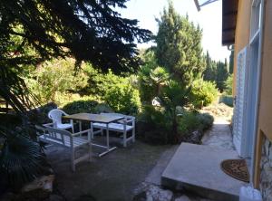 a patio with a table and two white chairs at Charming Rovinj Haven in Rovinj