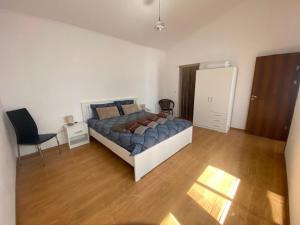 a bedroom with a bed and a desk and a chair at Holiday Villapark-Seaview Albena - Villa 1-2 in Rogachevo +49 photos