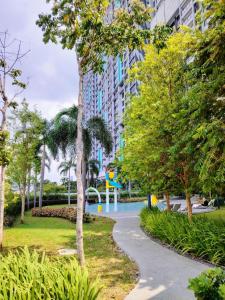 a walkway through a park with trees and a playground at Trion Residence Kuala Lumpur by Luxe in Kuala Lumpur