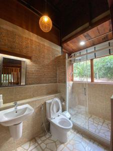 a bathroom with a toilet and a sink and a shower at Aan cafe&stay in Chiang Mai +30 photos