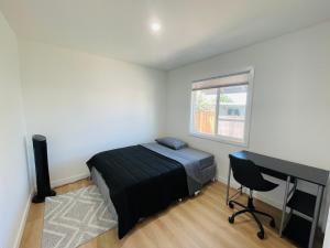 a bedroom with a bed and a desk and a computer at Cozy Home Silicon Valley 1 in San Jose