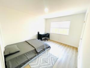 a bedroom with a bed and a chair and a window at Cozy Home Silicon Valley 1 in San Jose +3 photos