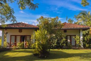 a house with a garden in front of it at Emel's Retreat By Tropical Magnum - Luxury Boutique Villa in Anhandigoda