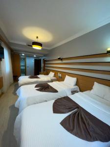 A bed or beds in a room at Quars Garden Hotel