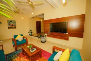 a living room with a large flat screen tv at Casa Das Imras Villa B in Calangute