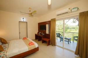 a bedroom with a bed and a balcony at Casa Das Imras Villa B in Calangute +27 photos