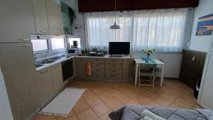 a kitchen with a sink and a counter with a table at Torino in vista -Monolocale con cucina in Turin +3 photos