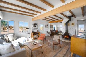 a living room with a couch and a fireplace at 2 Homes, Hot Tub, Firepit, BBQ, Games by MariamsBnb in Joshua Tree
