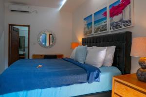 a bedroom with a blue bed and a mirror at Altea Villa Legian - 2BR Private Pool, Prime Location & Walk to Beach in Legian +36 photos